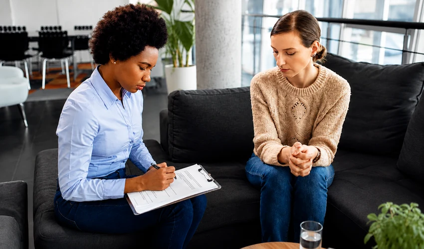 Counsellor supporting a woman during a private counselling session